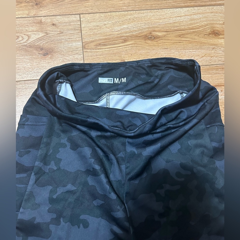 Black Camouflage mid length leggings/ athletic capris. Has pockets.